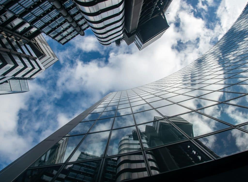 Glass office buildings seen from below, illustrating mortgage-backed securities and capital markets