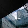 Tall financial district office tower viewed through glass, illustrating bank supervision and cybersecurity risks