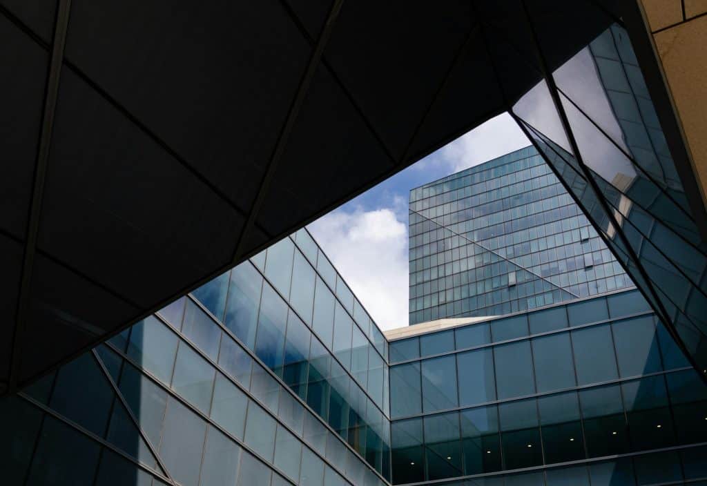 Tall financial district office tower viewed through glass, illustrating bank supervision and cybersecurity risks
