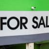 Residential for-sale sign, representative photo for first-time homebuyer negotiation survey.
