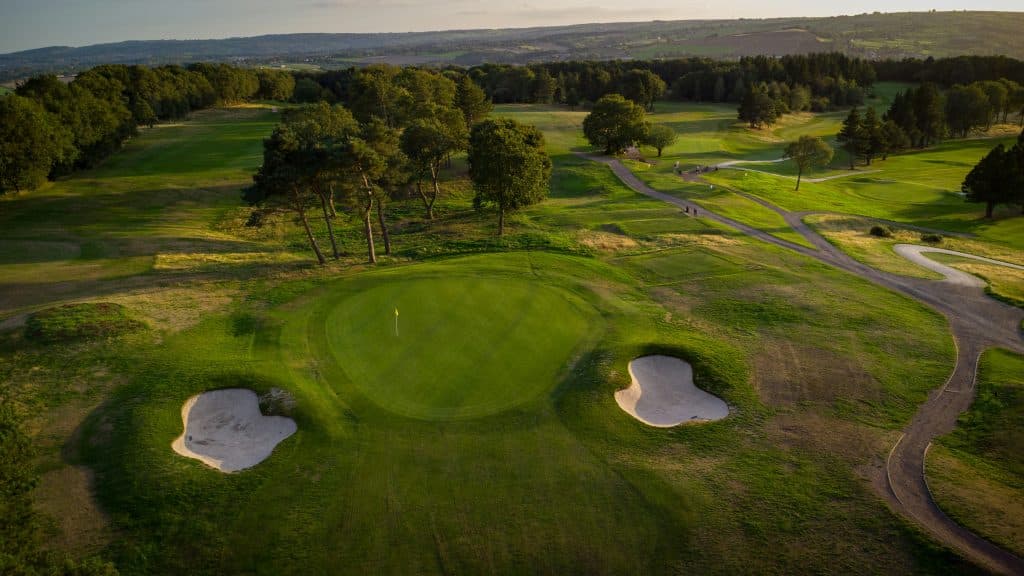 Aerial view of golf green and sand bunkers, illustrative of residential golf resort development