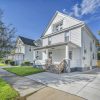 White two-story American home with front porch and lawn, illustrative image for FHA homebuyer down payment assistance
