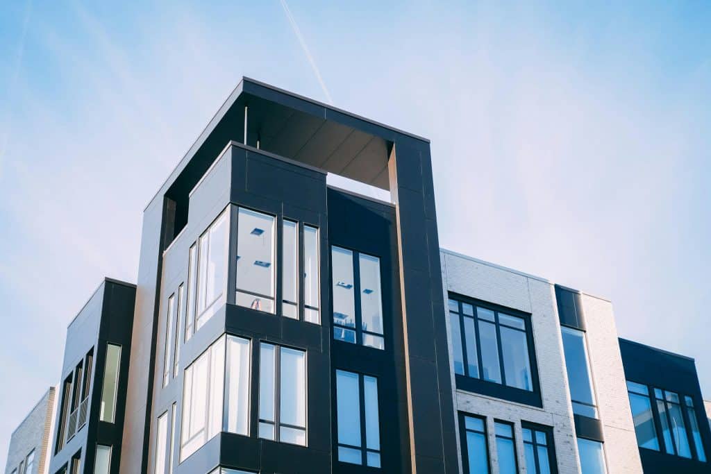Modern apartment building exterior, illustrating housing discrimination and rental access