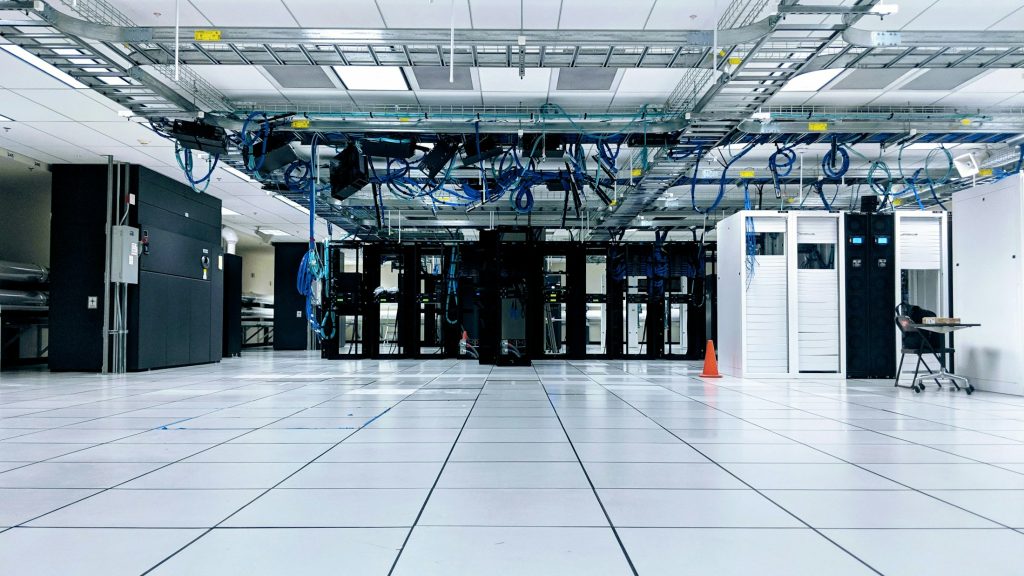 Illustrative photograph of a modern data center equipment hall; not a Nebius facility. Photo by Taylor Vick on Unsplash.