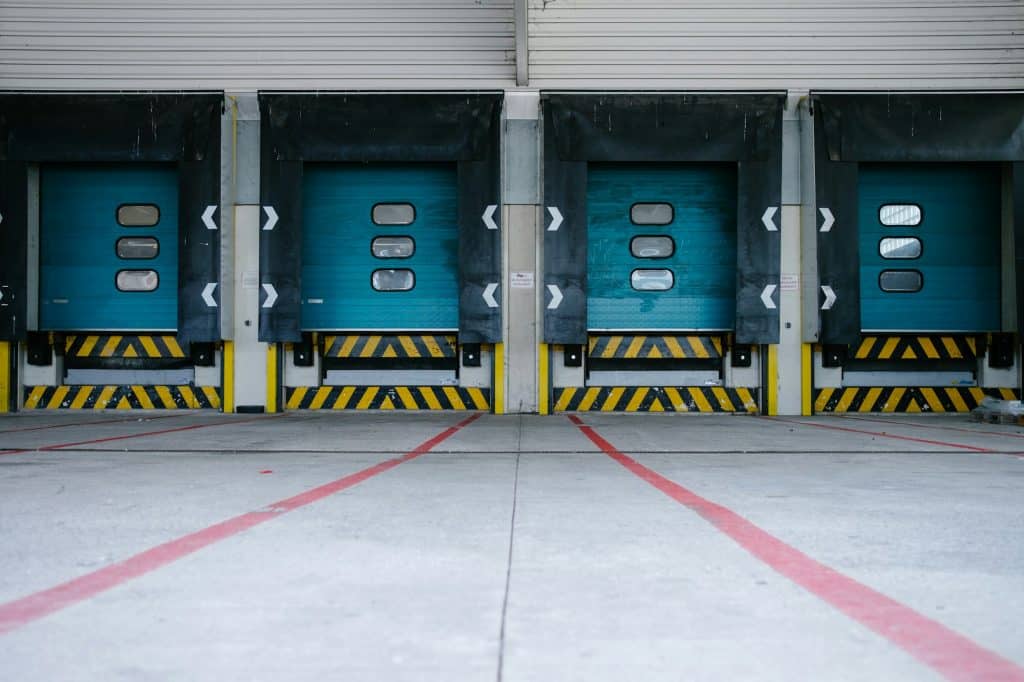 Colorful industrial loading doors at a commercial property; illustrative photograph, not a STAG asset