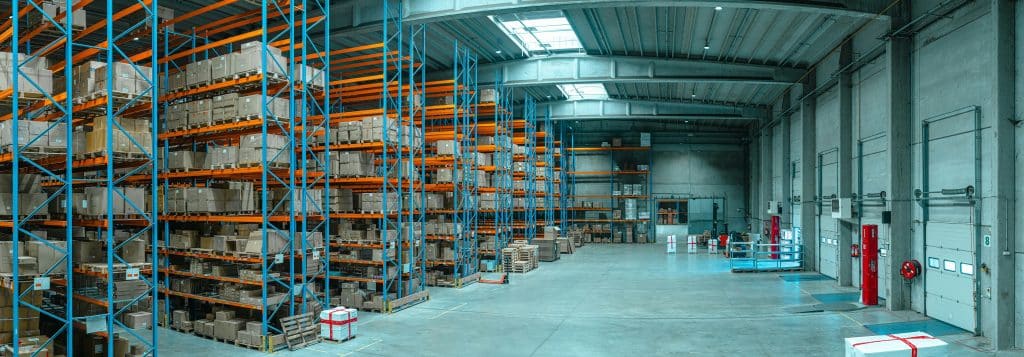 Large industrial building and loading facilities, illustrating net-lease property investment