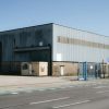 Large industrial distribution warehouse exterior, illustrative image