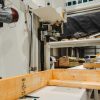 Industrial woodworking machinery processing timber inside a manufacturing facility