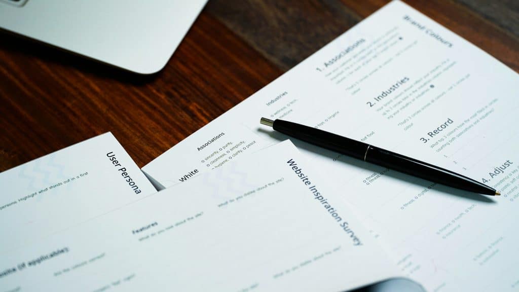 Pen resting on paperwork, illustrative image for mortgage insurance documentation