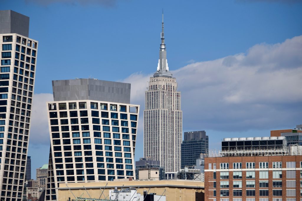 Midtown Manhattan skyline illustrating the Rithm Capital and DRA Advisors office joint venture