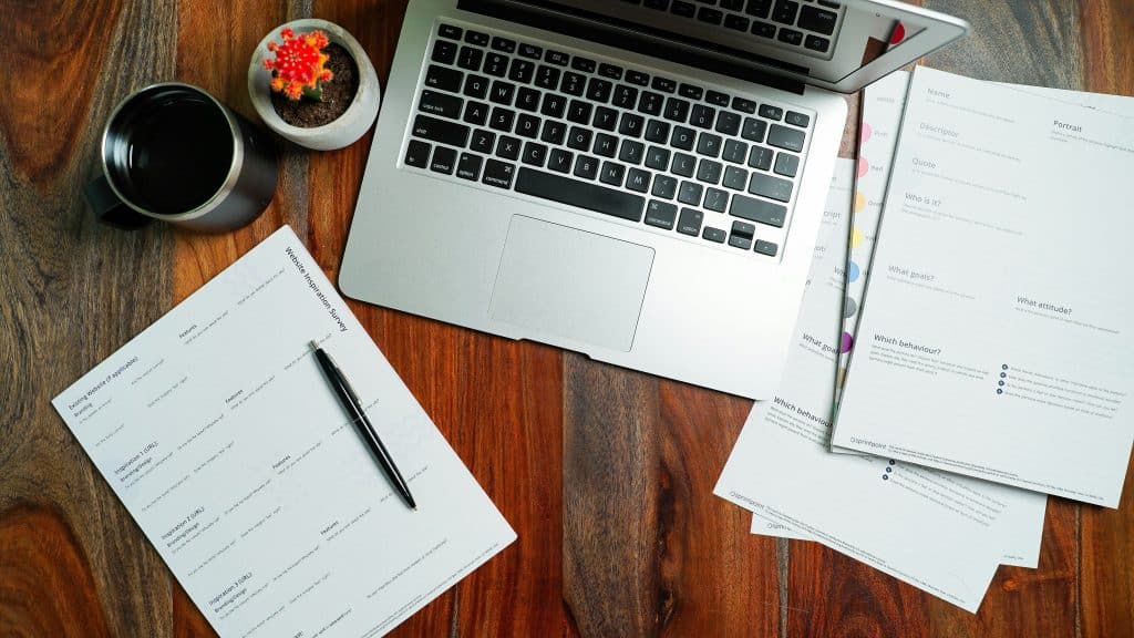 Laptop at desk illustrating credit-score processing, representative photo