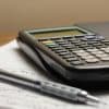 Calculator and pen on financial paperwork, illustrating mortgage rate-lock volume