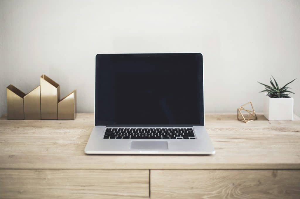 Laptop on desk, representative of mortgage software
