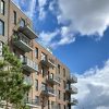 Modern multifamily apartment buildings with balconies, illustrative of apartment lease-up operations
