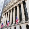 New York Stock Exchange building and American flags, where Apollo Commercial shares are expected to cease trading