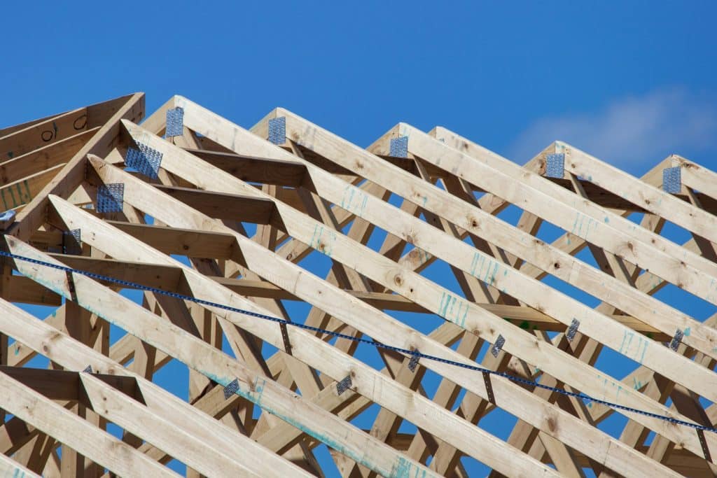 Timber and roof trusses on a home under construction, illustrating residential land development