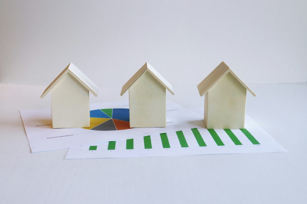 Small model houses on financial paperwork illustrating property-tax obligations