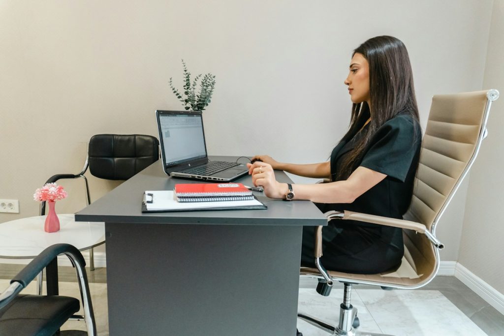 Real estate professional working at laptop, illustrative technology image
