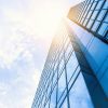 Glass office building facade; representative illustration of title insurance corporate leadership