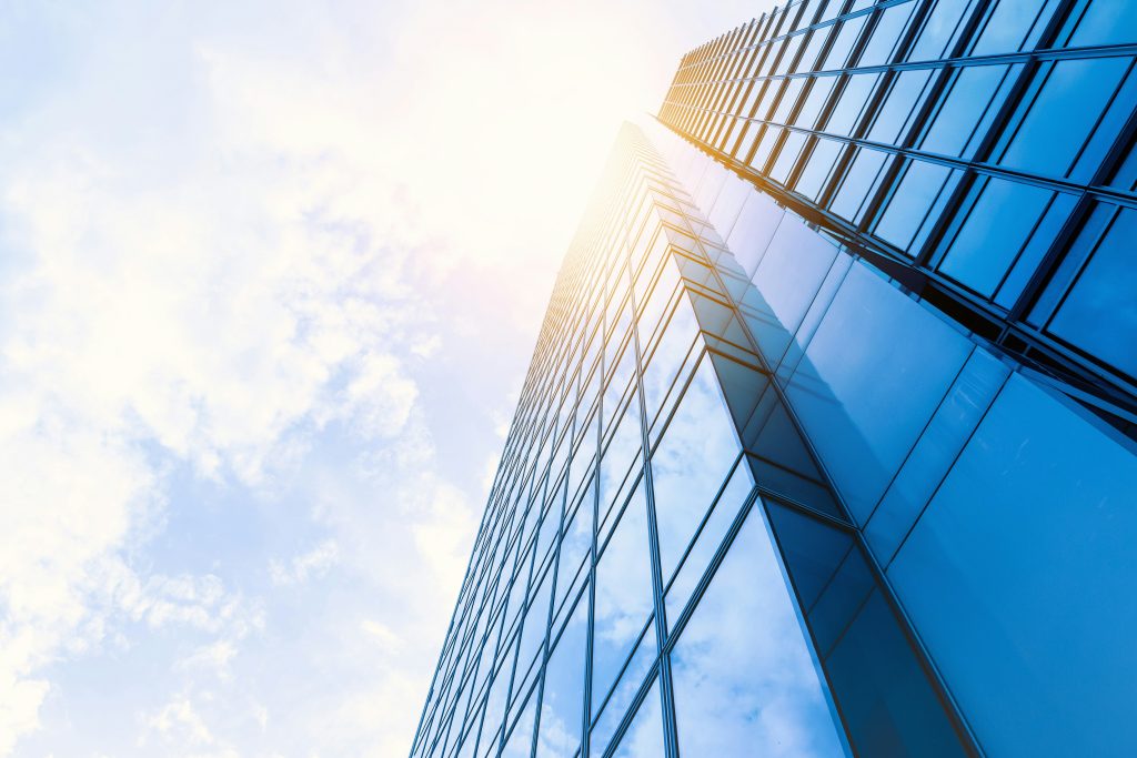 Glass office building facade; representative illustration of title insurance corporate leadership