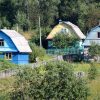 Residential homes in a green rural landscape, illustrative image for rural multifamily housing financing