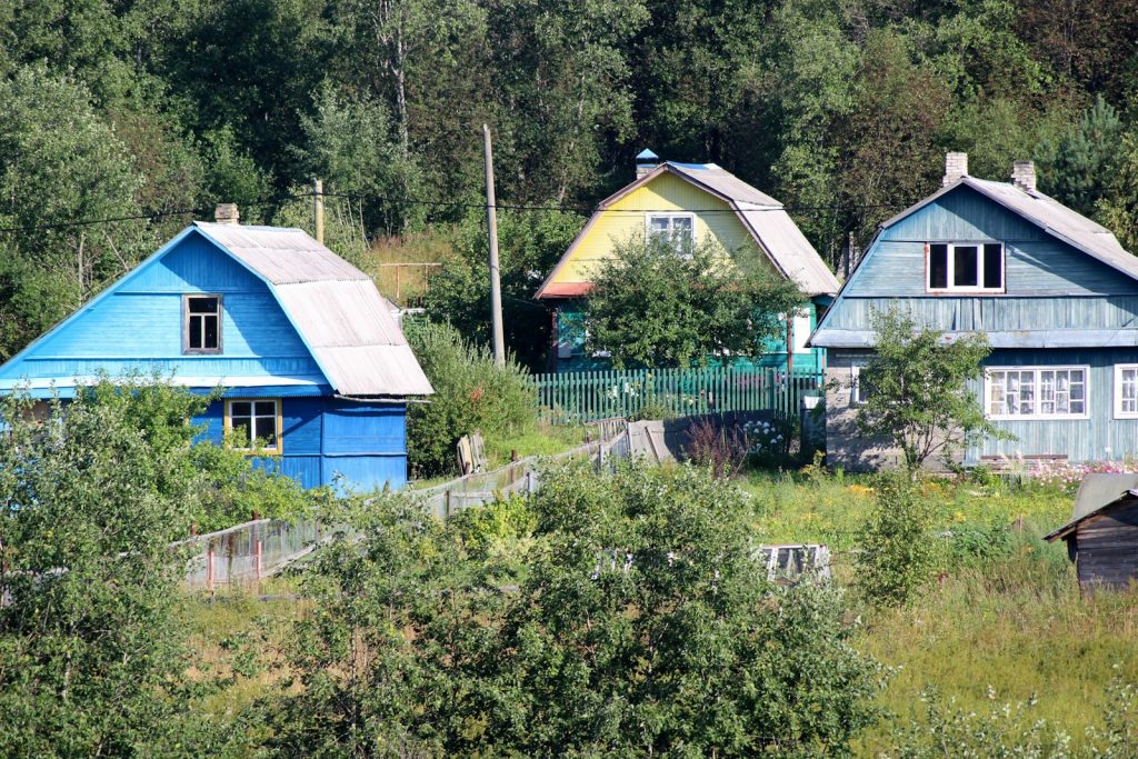 Residential homes in a green rural landscape, illustrative image for rural multifamily housing financing