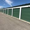 Rows of green self-storage facility doors, illustrative of CubeSmart's self-storage sector