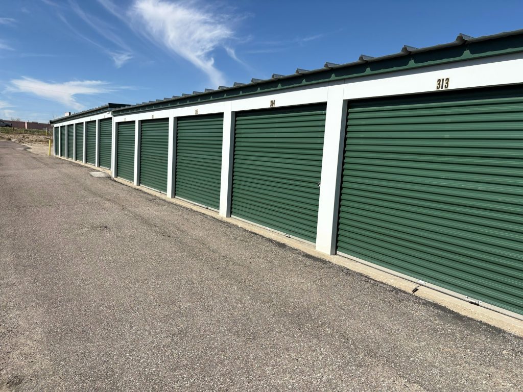 Rows of green self-storage facility doors, illustrative of CubeSmart's self-storage sector