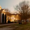 Residential community buildings and landscaped walking path in warm sunlight, illustrative image