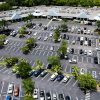 Aerial view of a retail shopping center parking lot, illustrative of commercial retail real estate