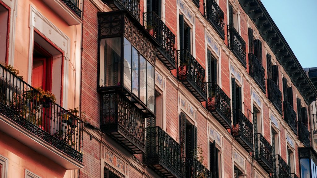 Residential-style building facade and balconies in Madrid, Spain, illustrative of Spain housing policy