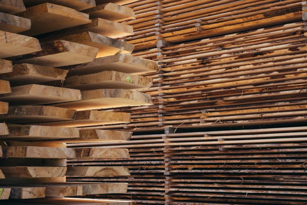 Stacked wood lumber illustrating forest products and the building materials market