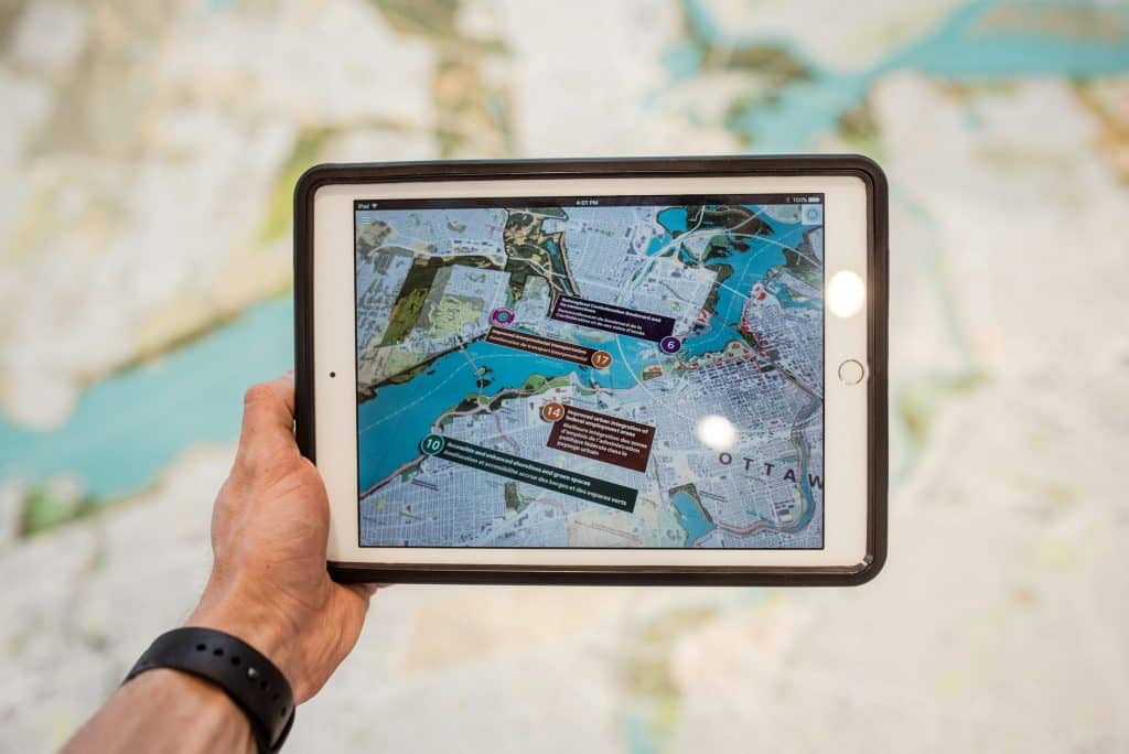 Person holding a tablet, illustrating commercial property data and digital management tools