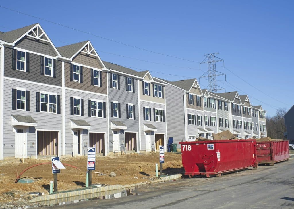 Row of townhouses under construction, illustrating the new-home market ahead of October 2026 economic releases