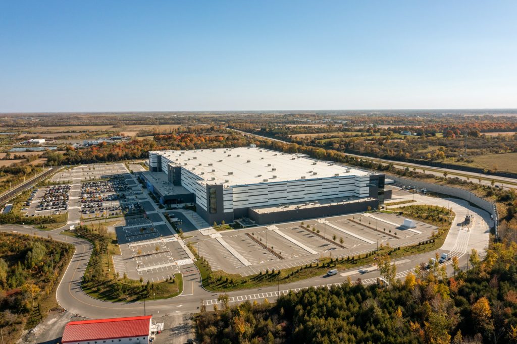 Large modern industrial warehouse and adjacent parking area, illustrating national industrial real estate supply